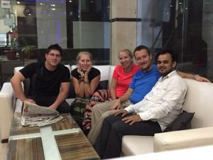 a group of people sitting on a couch at Hotel Saffron Inn in New Delhi