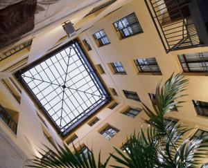 una gran ventana de cristal en un edificio con una planta en Catalonia Puerta del Sol, en Madrid