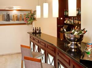 a bar with two chairs and a counter with bottles at Catalonia Puerta del Sol in Madrid +41 photos