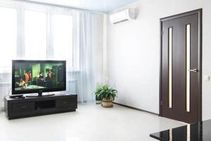 a living room with a flat screen tv on a stand at Просторная квартира на улице Бориса Гмыри 4 in Kyiv