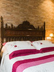 a bed with a white bedspread and pillows at Pension ARCA in O Pedrouzo