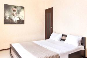 a bedroom with a bed with a picture on the wall at Просторная квартира на улице Бориса Гмыри 4 in Kyiv