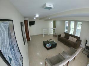 a living room with a couch and a table at Hotel Villa Brites in Mauá