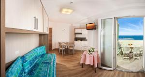 a living room with a table and a dining room at Beach Residence in Gabicce Mare