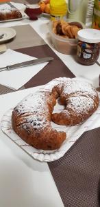 two breads sitting on a paper plate on a table at B&B Le Dune Beach in San Leone