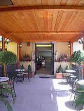 a lobby with tables and chairs and an open door at Hotel Nardizzi Americana in Rome