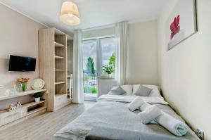 Łóżko lub łóżka w pokoju w obiekcie Apartamenty Novomiejska 17