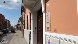 a building with a sign on the side of a street at Centro Storico Suites in Ferrara
