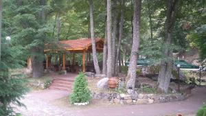 a gazebo in the middle of a forest at Hotel Valdis in Pastra