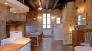 a kitchen and dining room with a table and stairs at Rue Bertrand de Got in Saint-Cyprien