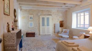 a large living room with a stone wall at Rue Bertrand de Got in Saint-Cyprien