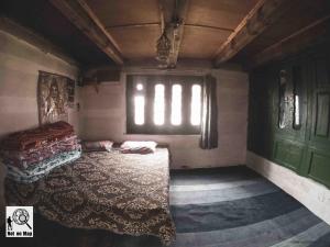 a bedroom with two beds and a window at NotOnMap - Adobe The Cloud in Chitkul