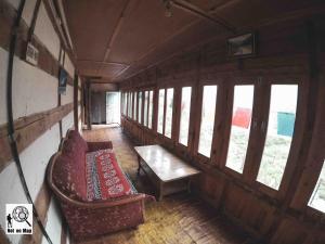 a room with a couch and a table in a train at NotOnMap - Adobe The Cloud in Chitkul
