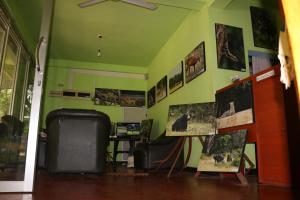 a room with a green wall with pictures on it at Wilpattu Dolosmahe in Wilpattu
