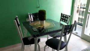 a green dining room table with a plant on it at Apartamento Edificio Ajuricaba in Manaus