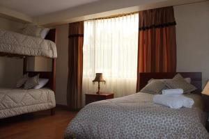 a bedroom with a large bed and a window at Hotel Marquez de Guano in Guano