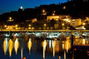un porto turistico notturno con barche in acqua di Estrella del Norte a Villaviciosa