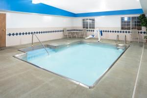 a large swimming pool in a room with at Microtel Inn & Suites by Wyndham Springfield in Springfield