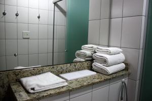 a white towel sitting on top of a towel rack at Apto no Union Residence in Novo Hamburgo