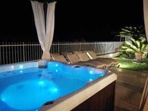 a jacuzzi tub on a patio at night at Le Villette - Taormina in Taormina