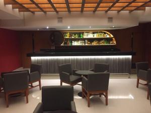 a bar with a table and chairs and a piano at Lisboa Hotel in Mexico City +10 photos