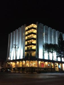 a large building with lights on it at night at Lisboa Hotel in Mexico City