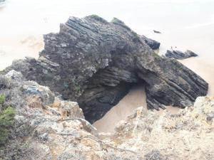 a rock formation on a beach near the ocean at Sol Mar in Odeceixe
