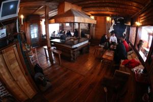 a group of people sitting at a bar in a restaurant at Apartman Pustolov - Stara planina in Crni Vrh