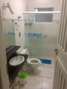 a bathroom with a toilet and a sink at Flats Paraty in Paraty