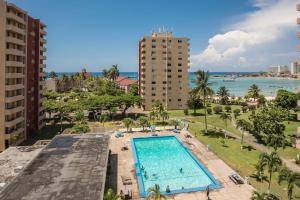 an aerial view of a swimming pool and the ocean at Turtle Beach Towers in Ocho Rios