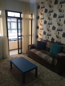 a living room with a couch and a coffee table at Apartamento New Life in Fortaleza +22 photos