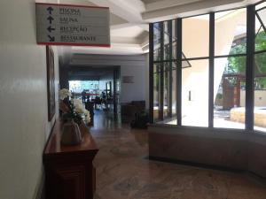 a lobby of a building with a vase of flowers at Apartamento New Life in Fortaleza