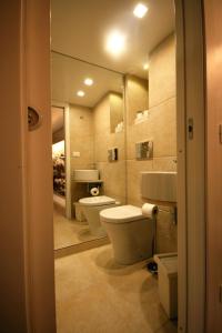 a bathroom with two toilets and a mirror at La Vecchia Stalla in Palermo +44 photos