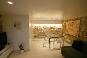 a living room with a glass table and a couch at La Vecchia Stalla in Palermo