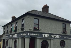 a building with a sign that reads the squat public house at The Rooms at The Spout in Kilcullen
