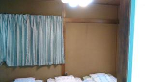 a bedroom with two beds and a window in it at "Cherry House" is Direct to Narita,Haneda AP, Disney, Asakusa, Skytree Tower, Tokyo in Matsudo +143 photos