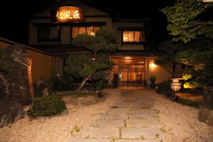 ein Haus in der Nacht mit einem Gehweg davor in der Unterkunft Jinpuso in Miyazu
