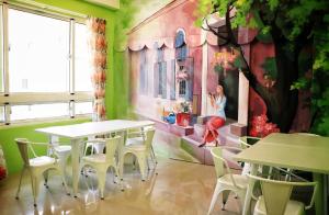 太平村的住宿－英倫爵士，一间设有桌椅的房间和墙上的绘画