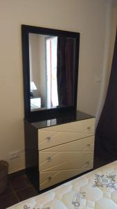 a dresser with a mirror on top of it at Apartment in Porto Sharm VIP in Sharm El Sheikh