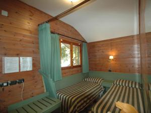 a room with two chairs and a window at Residence Villaggio Verde in Sorrento
