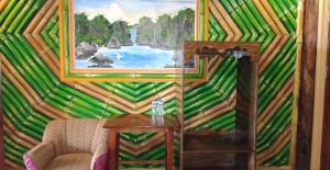 a living room with a painting on the wall at Ausan Beach Front Cottages in San Vicente