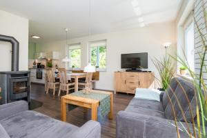 a living room with a couch and a table at Fehmarn Mein Urlaub in Fehmarn
