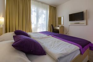 Postel nebo postele na pokoji v ubytování Hotel Slaven