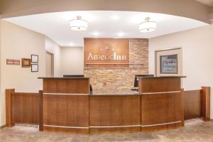 a lobby of an american inn with a reception desk at AmericInn by Wyndham Humboldt in Humboldt