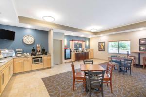 a kitchen and dining room with a table and chairs at AmericInn by Wyndham Humboldt in Humboldt