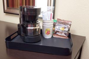 a coffee maker sitting on top of a table at Super 8 by Wyndham Chicago Northlake O'Hare South in Northlake