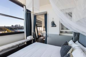 a bedroom with a bed and a window at Hotel Palisade in Sydney