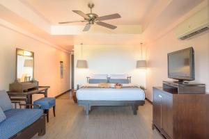a bedroom with a bed and a flat screen tv at Krabi Chada Resort - SHA Plus in Ao Nang Beach