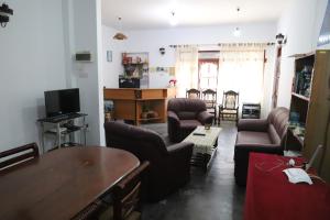 a living room with a couch and chairs and a table at Prasad Suomi Villa in Matara