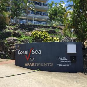a sign for the coral sea aquarium at a resort at Coral Sea Vista Apartments in Airlie Beach